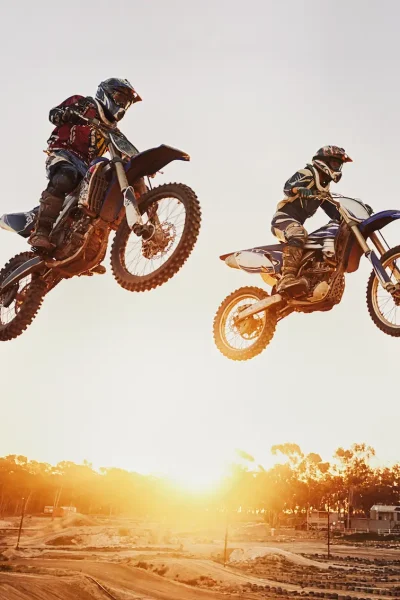 jumping-over-the-sunset-a-shot-of-two-motocross-r-2025-04-06-09-19-05-utc